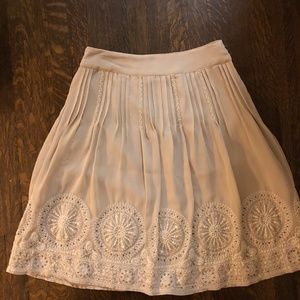 Elegant, embroidered, fully lined, pleated skirt.